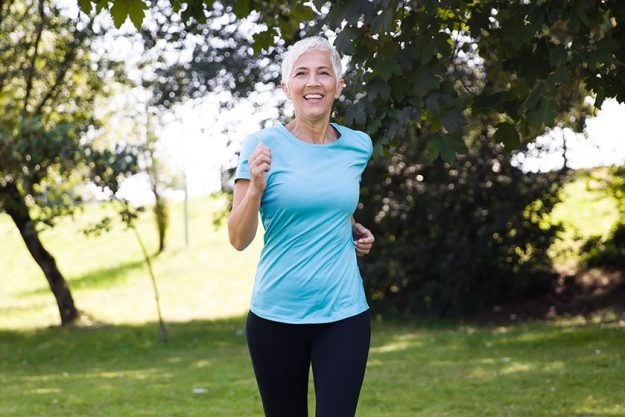 Remove BG  Save  Share  Sample  Front view of senior woman jogging through park Remove BG Save Share Sample Front view of senior woman jogging through park