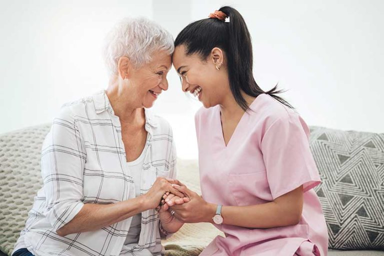 The honour of friendship. a young nurse caring for an older woman inside The honour of friendship. a young nurse caring for an older woman inside