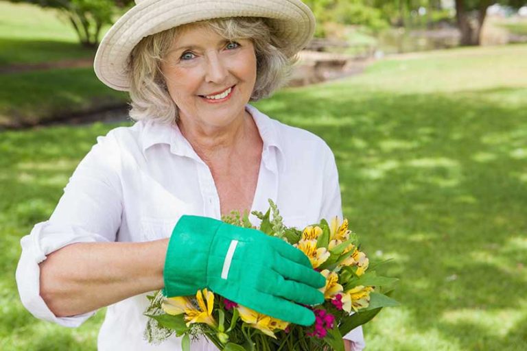 Mature woman holding plant