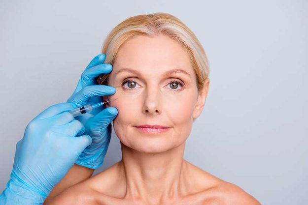 Portrait of calm serious charming aged woman with wrinkle gettin Portrait of calm serious charming aged woman with wrinkle gettin