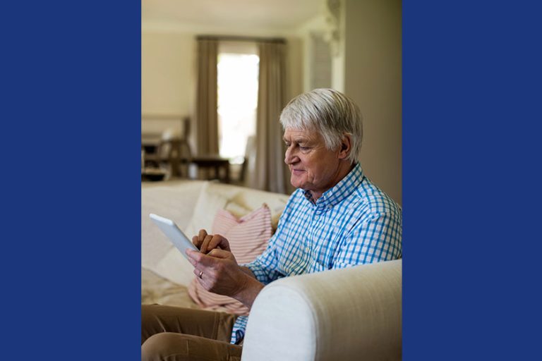 Senior man using tablet in living room Senior man using tablet in living room