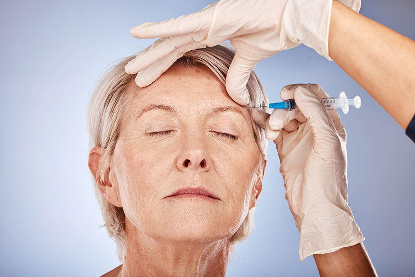 Skincare, mature woman and botox injection from healthcare professional for anti aging treatment for wrinkles on forehead. Beauty, facial wellness and a senior lady getting collagen filler injected Skincare, mature woman and botox injection from healthcare professional for anti aging treatment for wrinkles on forehead. Beauty, facial wellness and a senior lady getting collagen filler injected