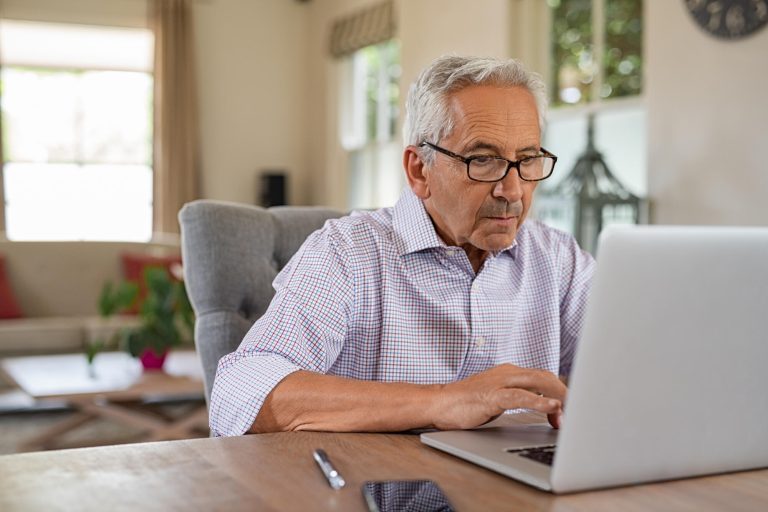 Senior,Man,Working,With,Laptop,At,Home.,Old,Man,Using