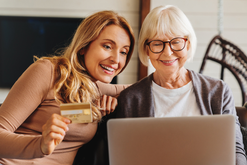 Shopping online. Senior woman and her middle aged daughter shopping online using laptop computer Shopping online. Senior woman and her middle aged daughter shopping online using laptop computer