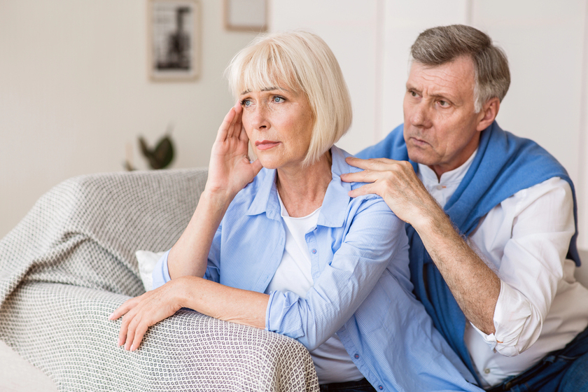 Mature husband and wife arguing, man trying to resolve family conflict at home