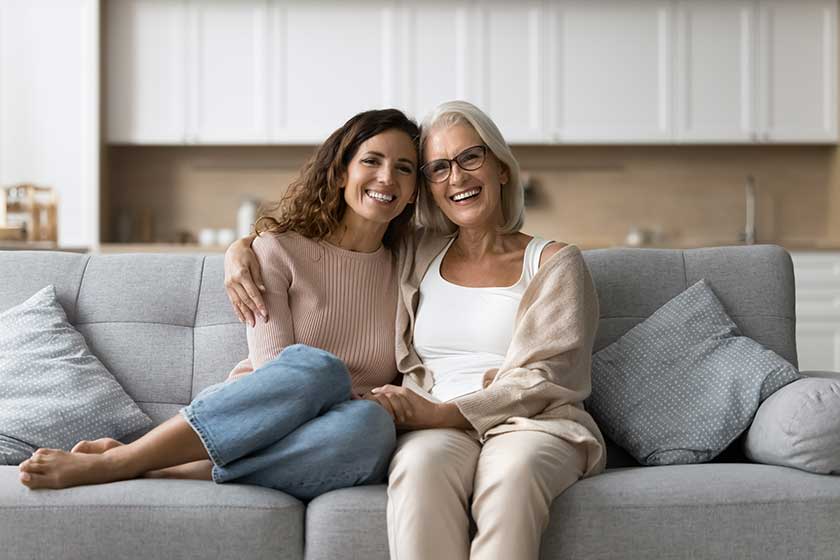 Cheerful-senior-mother-daughter-woman-sitting-home-couch-close-together Cheerful-senior-mother-daughter-woman-sitting-home-couch-close-together