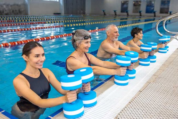 Exercise-dumbbells-group-seniors-having-exercise-dumbbels-water-aerobics-class Exercise-dumbbells-group-seniors-having-exercise-dumbbels-water-aerobics-class