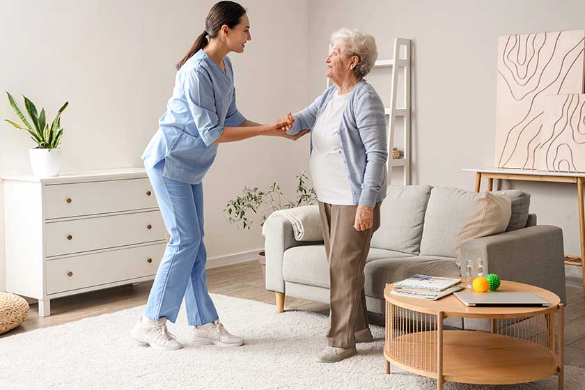 Physical-therapist-helping-senior-woman-to-walk-at-home Physical-therapist-helping-senior-woman-to-walk-at-home