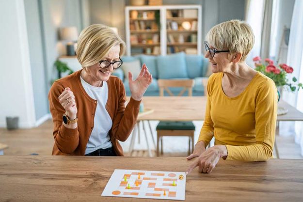 Two-senior-women-female-woman-friends-family-sisters-play-leisure Two-senior-women-female-woman-friends-family-sisters-play-leisure