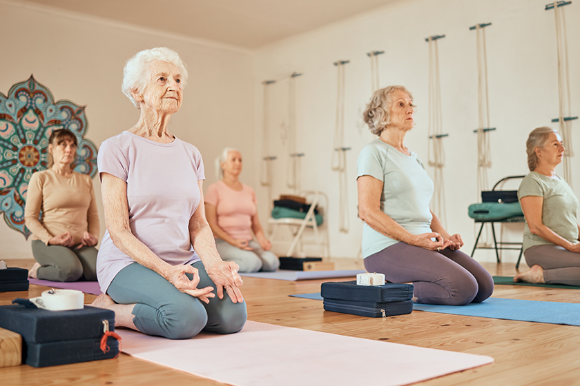 yoga-lotus-group-senior-women-gym-meditating