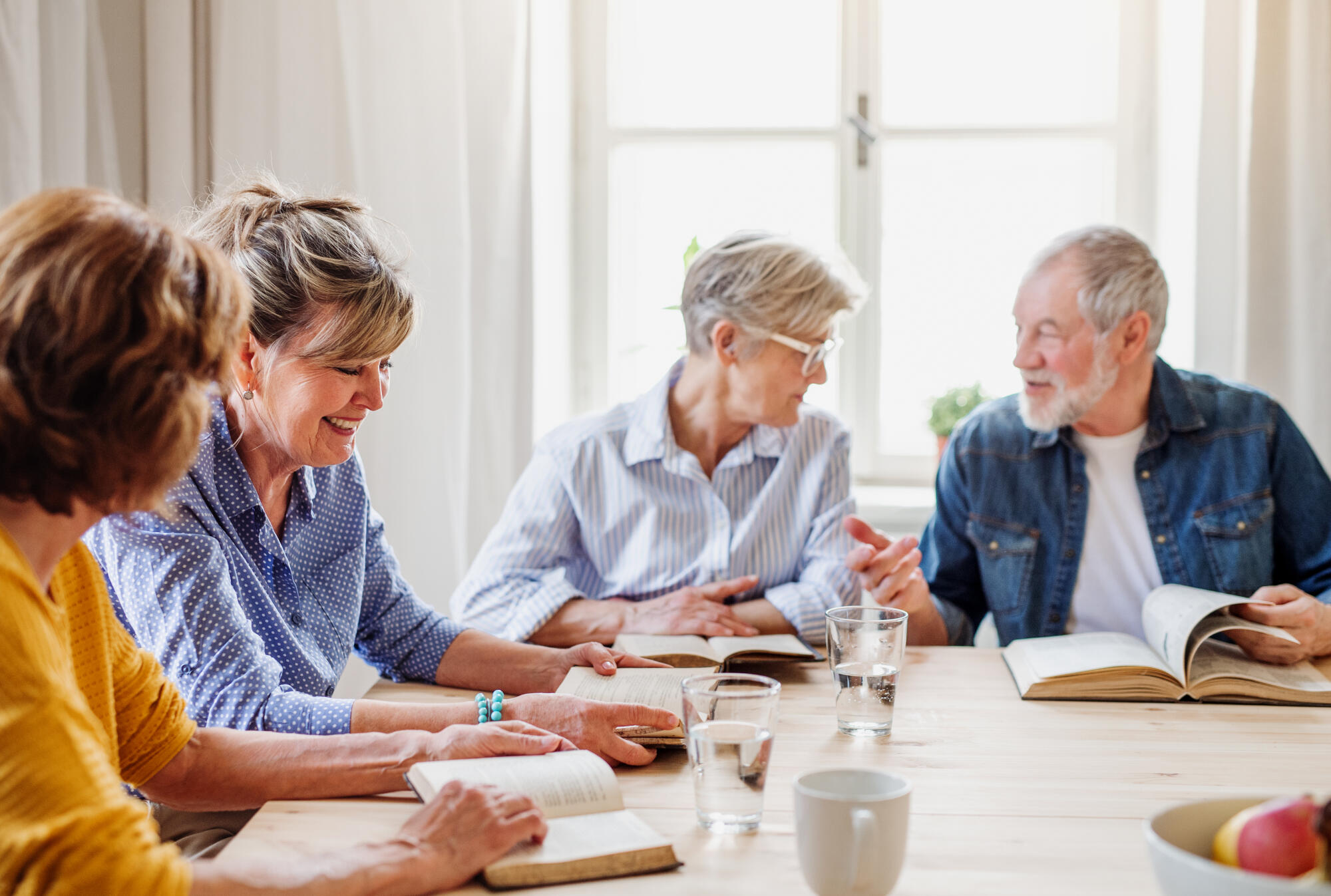 Senior,People,In,Bible,Reading,Group,In,Community,Center,Club.