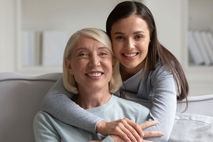 Head shot portrait mature grandmother and granddaughter hugging Head shot portrait mature grandmother and granddaughter hugging