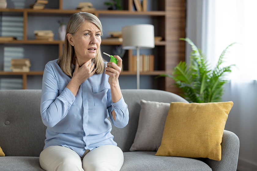 Mature woman experiencing sore throat