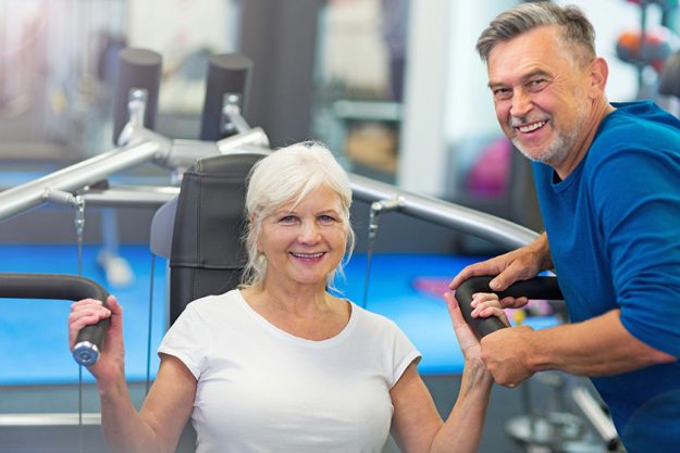 Senior couple exercising in gym