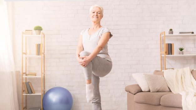 Woman Doing Yoga Pose in Living Room at Home