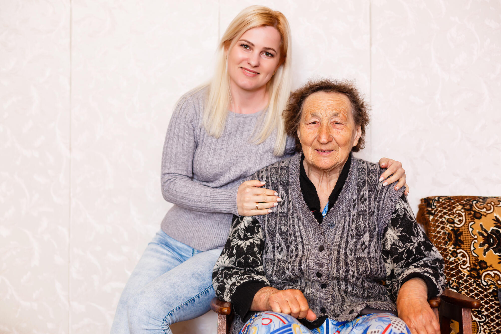 Senior woman with her caregiver at home