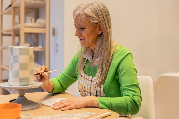 focused-elderly-woman-carefully-painting focused-elderly-woman-carefully-painting