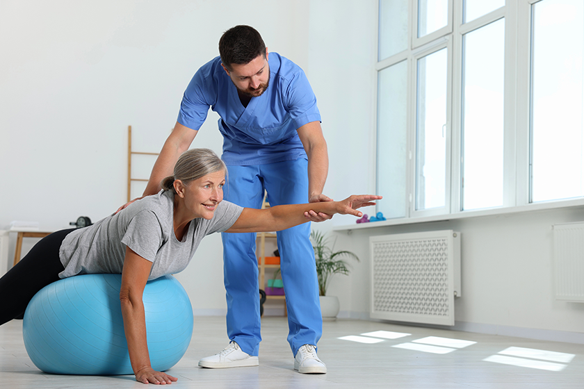 physiotherapist-working-senior-patient-rehabilitation-center
