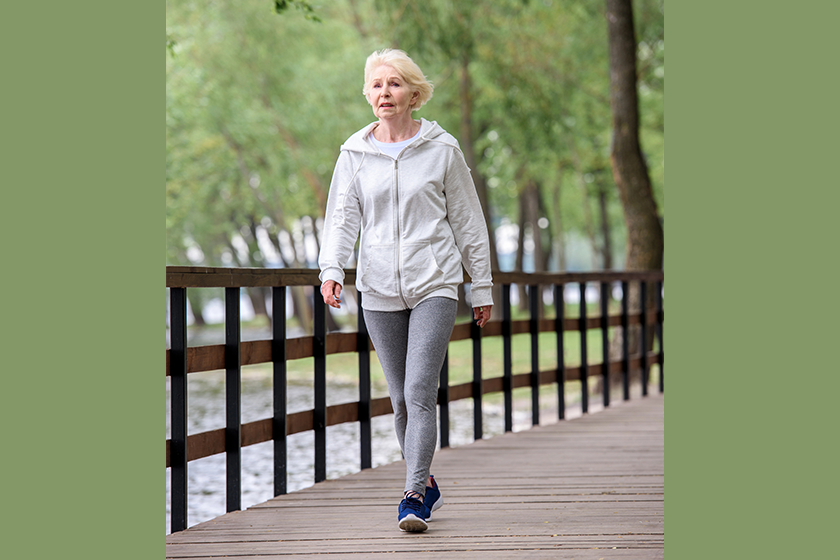senior-woman-sportswear-walking-wooden-path senior-woman-sportswear-walking-wooden-path