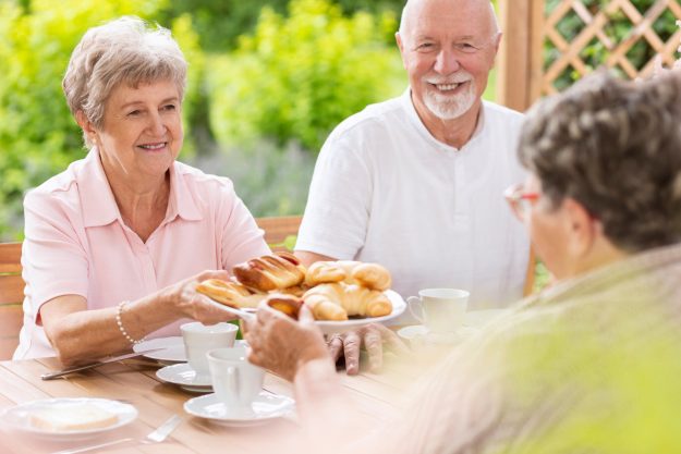 A,Woman,In,Her,Old,Age,Handing,Pastry,To,Her