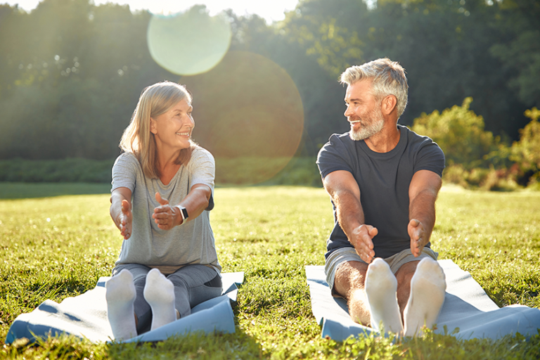 In a beautiful sunlit park, mature couple