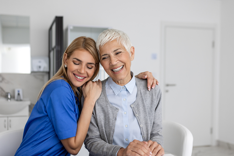 The elderly woman enjoys an embrace from her favorite healthcare