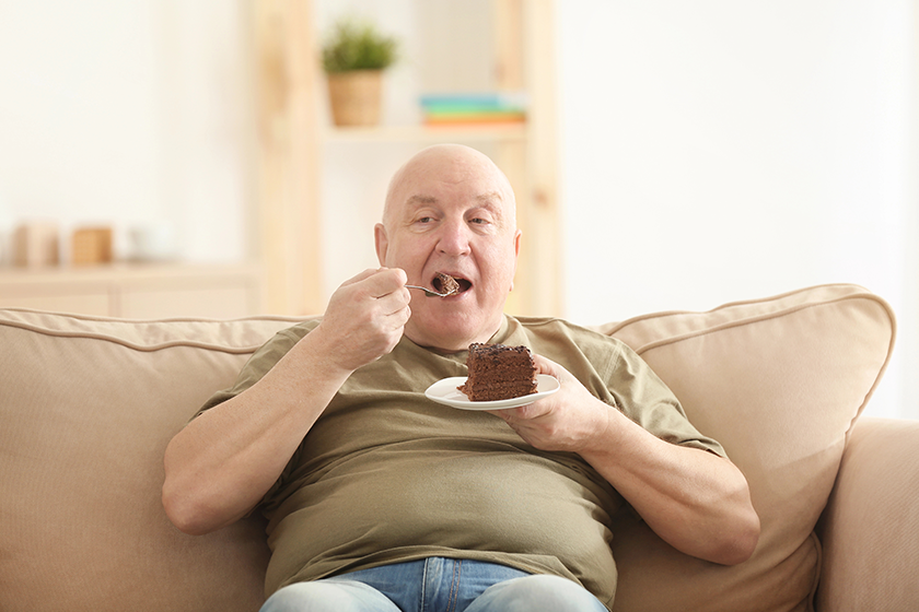 fat-senior-man-eating-cake-while-sitting Fat senior man eating cake while sitting