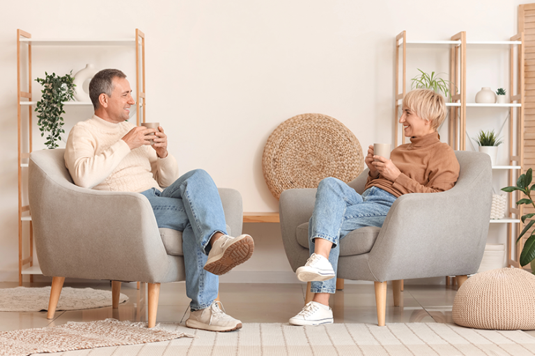 senior-couple-cups-tea-sitting-armchairs Senior couple with cups of tea sitting on armchairs