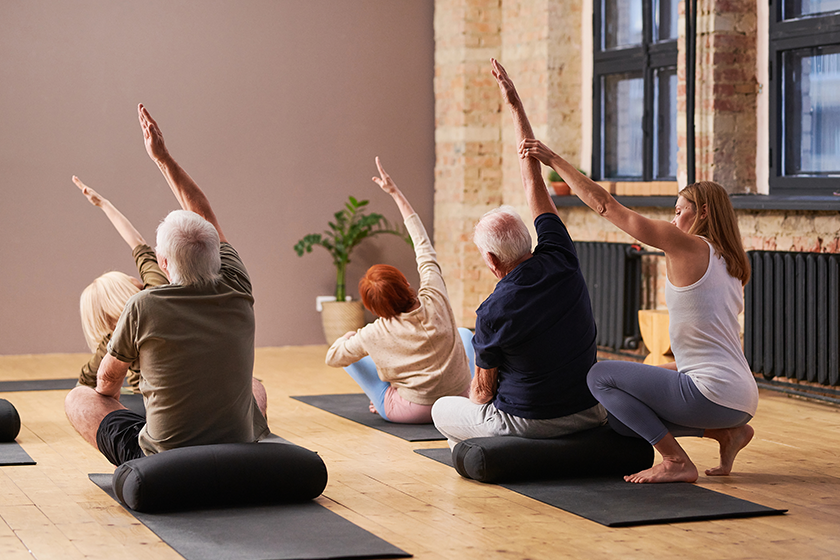 young-female-fitness-trainer-helping-senior-man Young female fitness trainer helping senior man