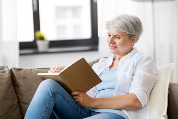 senior-woman-writing-to-notebook Senior woman writing to notebook or diary