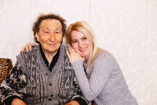 Senior woman with her caregiver at home