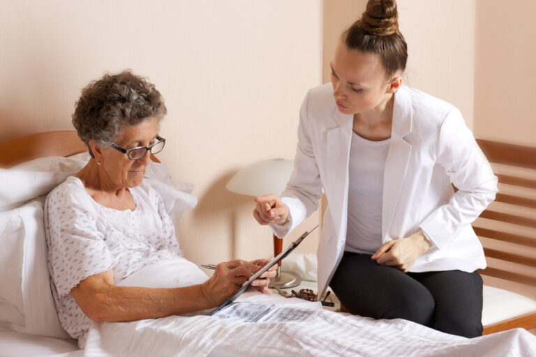 Visit of senior social work assistant to an old woman