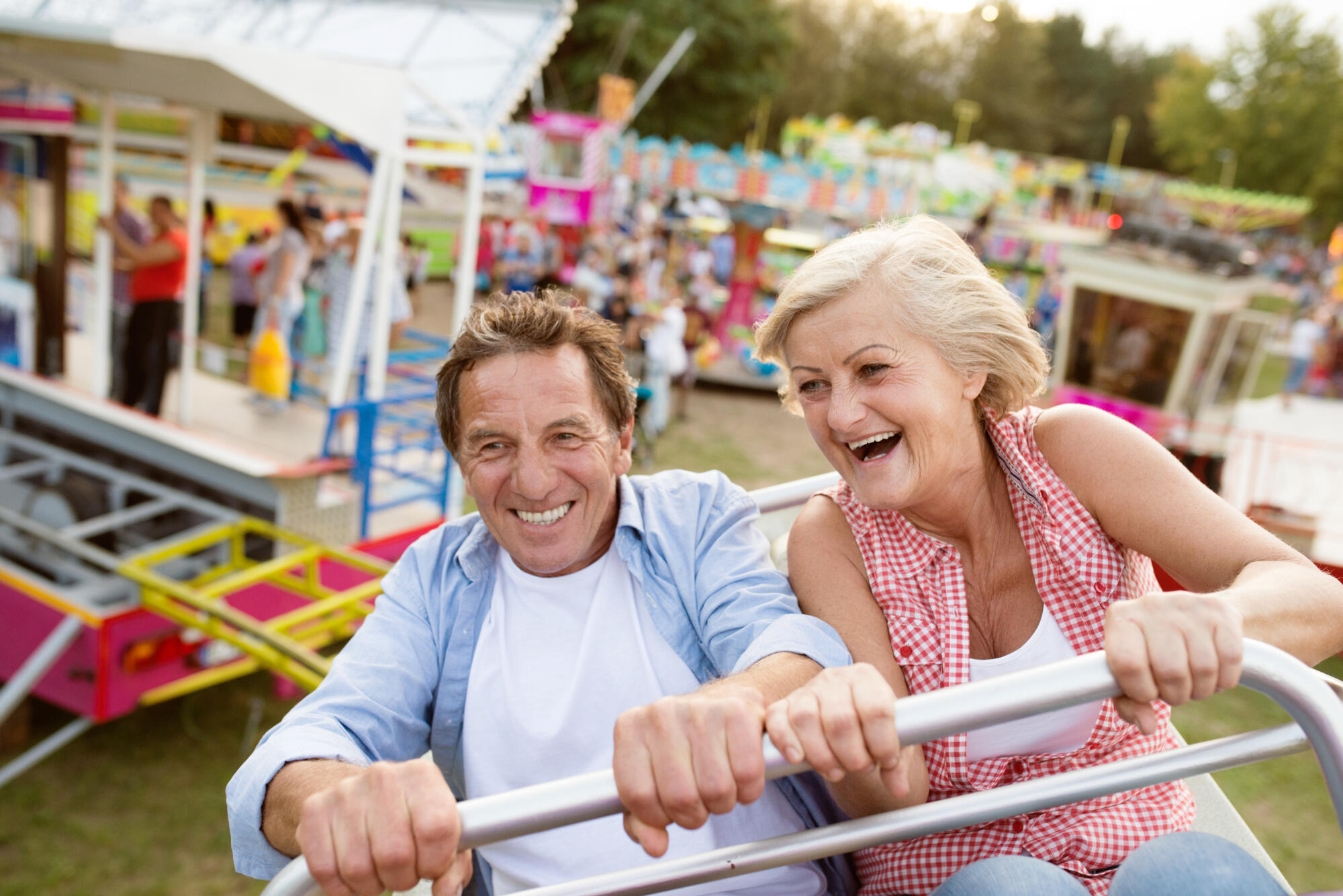 Senior,Couple,On,A,Ride,In,Amusement,Park