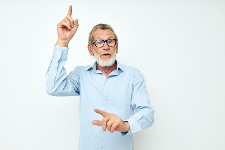 Senior grey-haired man in shirt and glasses posing emotions isolated background