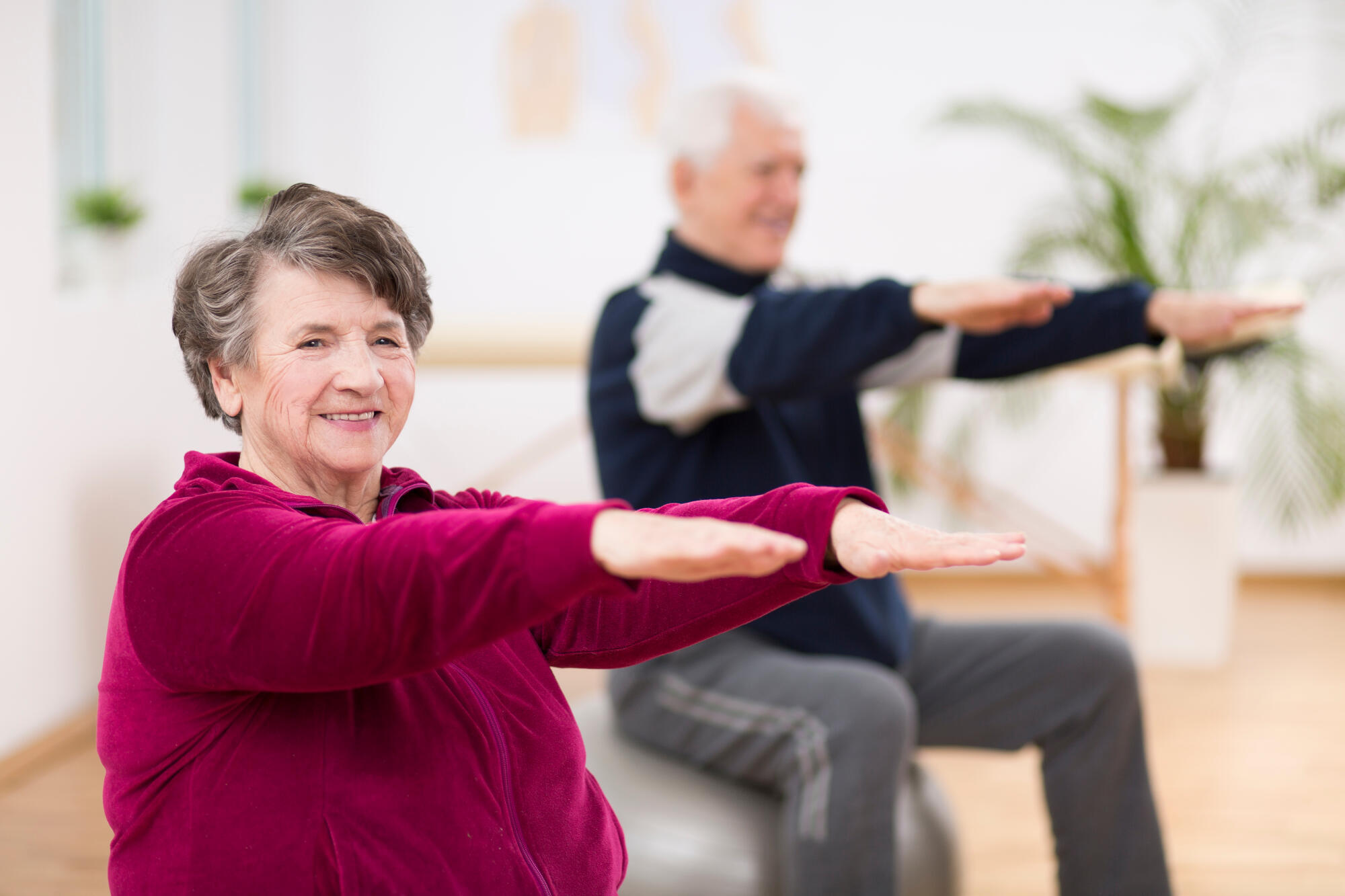 Elderly,Woman,Exercising,During,Pilates,For,Seniors,In,Retirement,Home