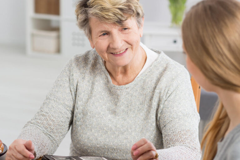 Senior,Lady,Sitting,At,A,Table,With,A,Cup,Of