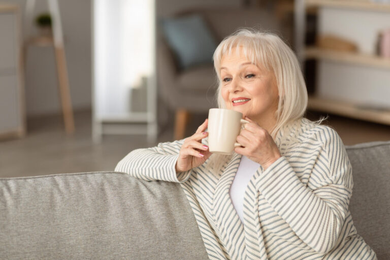 Portrait of smiling mature woman drinking hot coffee